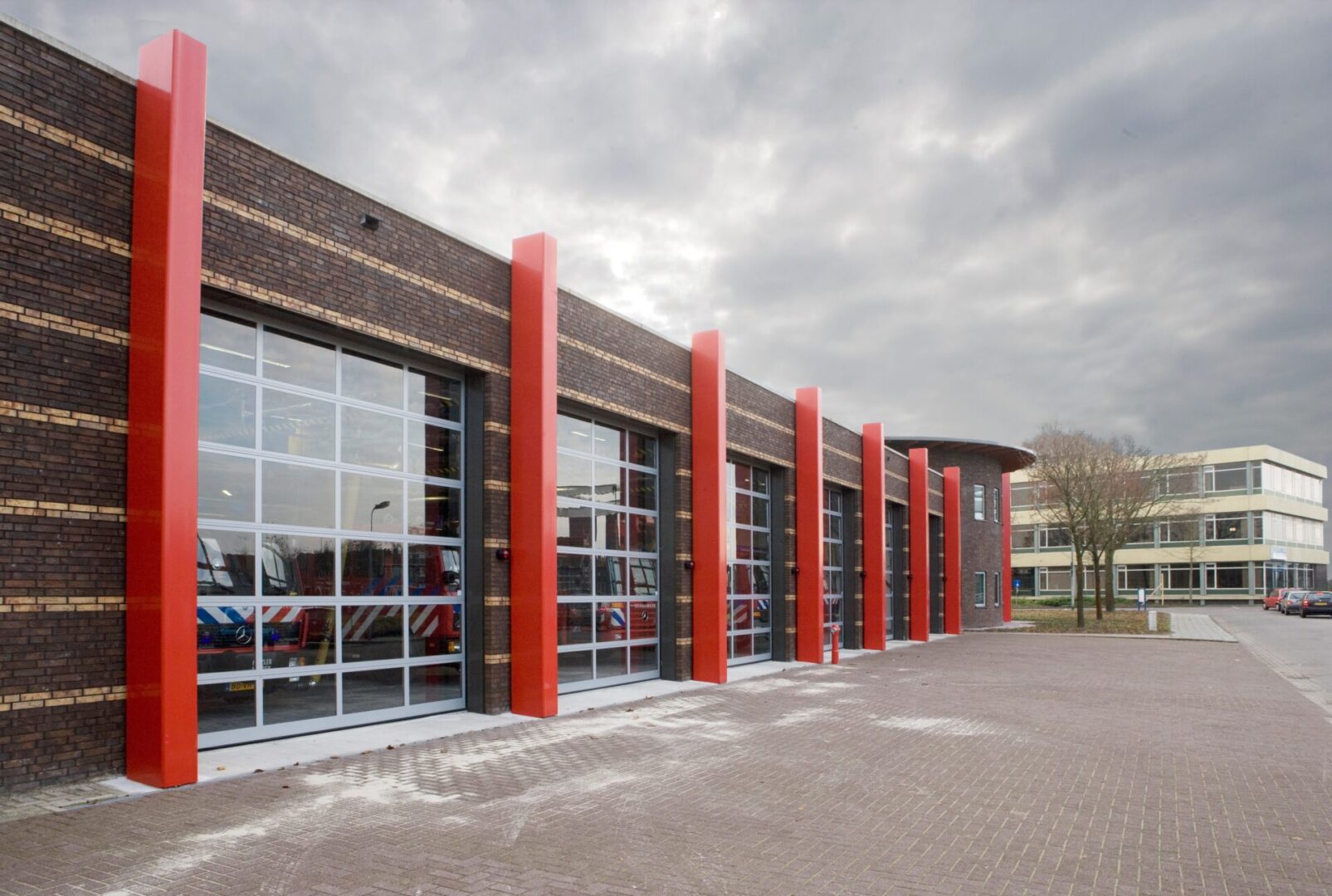 A building with many windows and red trim.