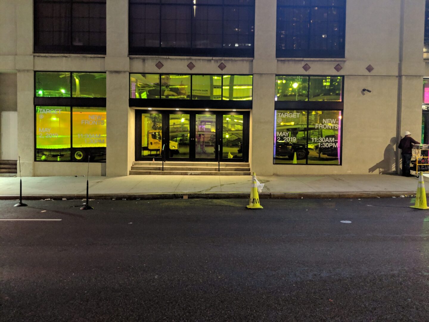 A street corner with a yellow and white pole